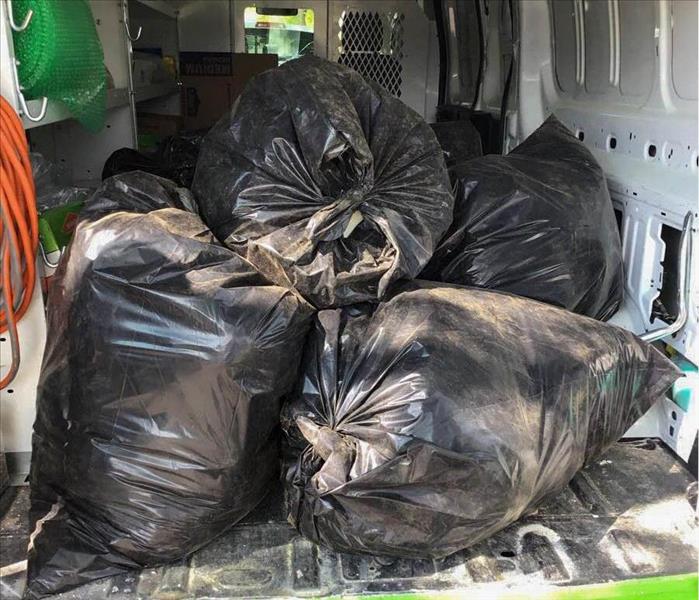 Trash bags with damaged material after water loss