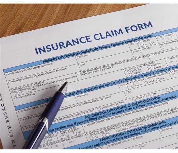 Insurance claim form with a pen on top of the form.