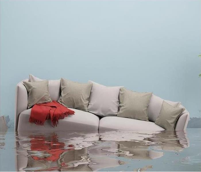 sofa with cushions floating in water inside a house
